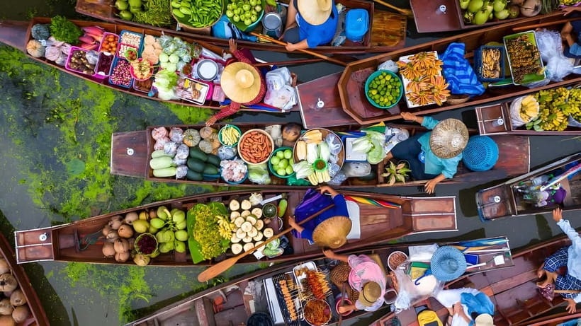 Bangkok: Railway, Floating Market & Chao Phraya Cruise Tour - A boat-level view of Damnoen Saduak