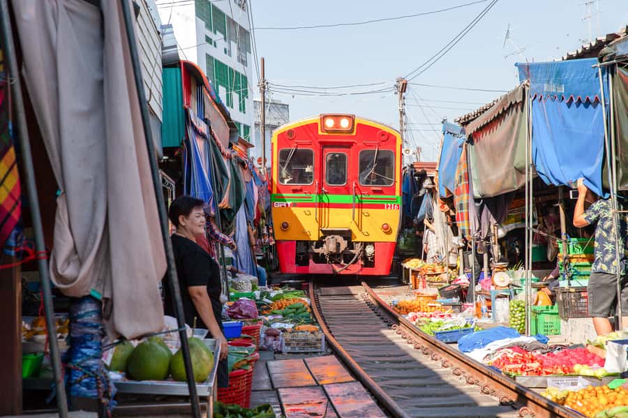 From Bangkok: Maeklong Railway and Floating Market Food Tour - What the guides add to the experience