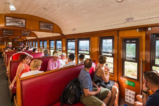 Passengers in the wooden carriage of a heritage tourist train